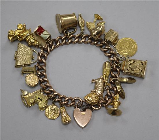 A 9ct gold charm bracelet hung with twenty two assorted mainly 9ct gold charms including yacht, acorn and carriage clock.